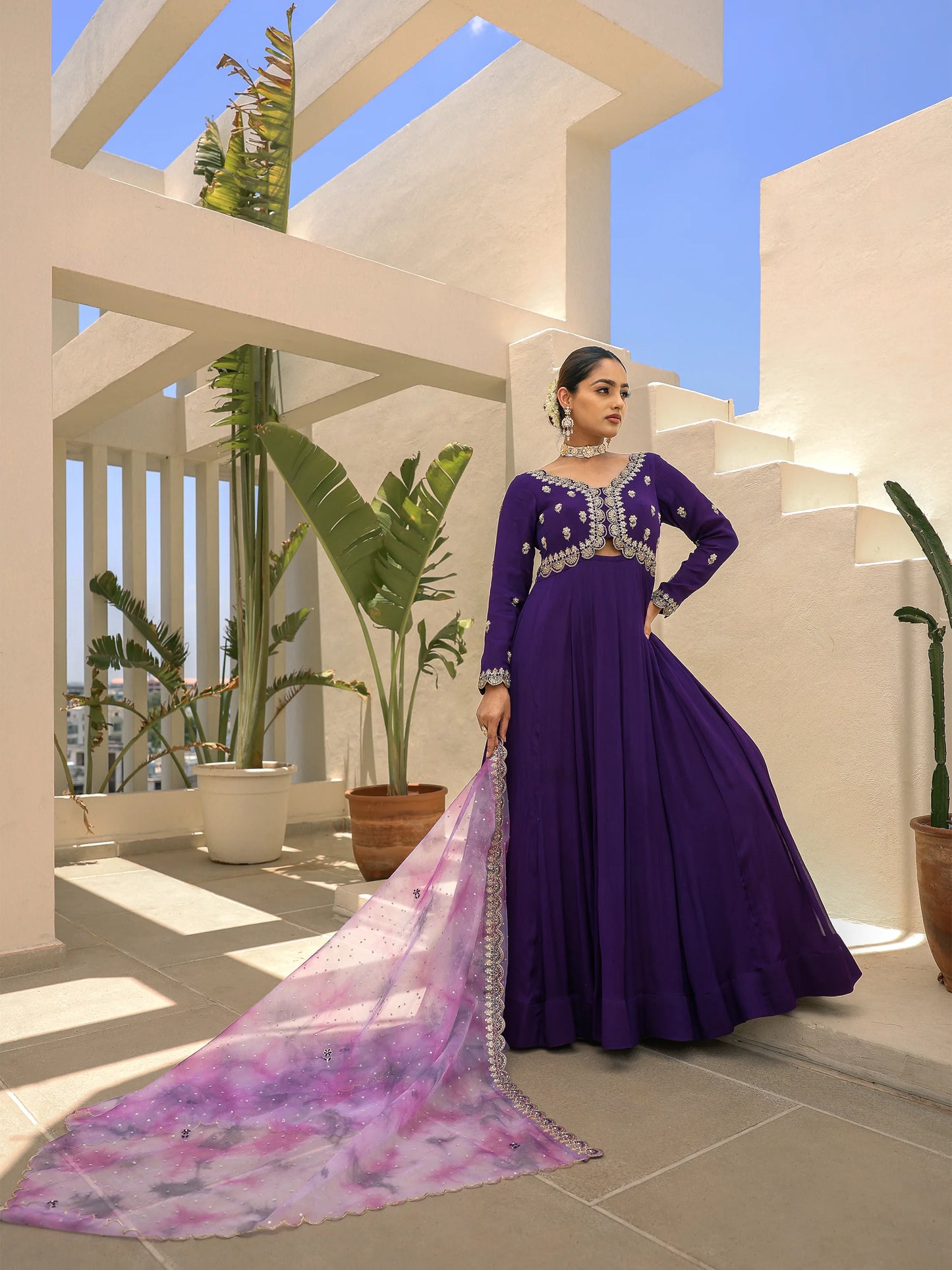 Full view of a woman in an embroidered anarkali paired with a lavender-purple dupatta.