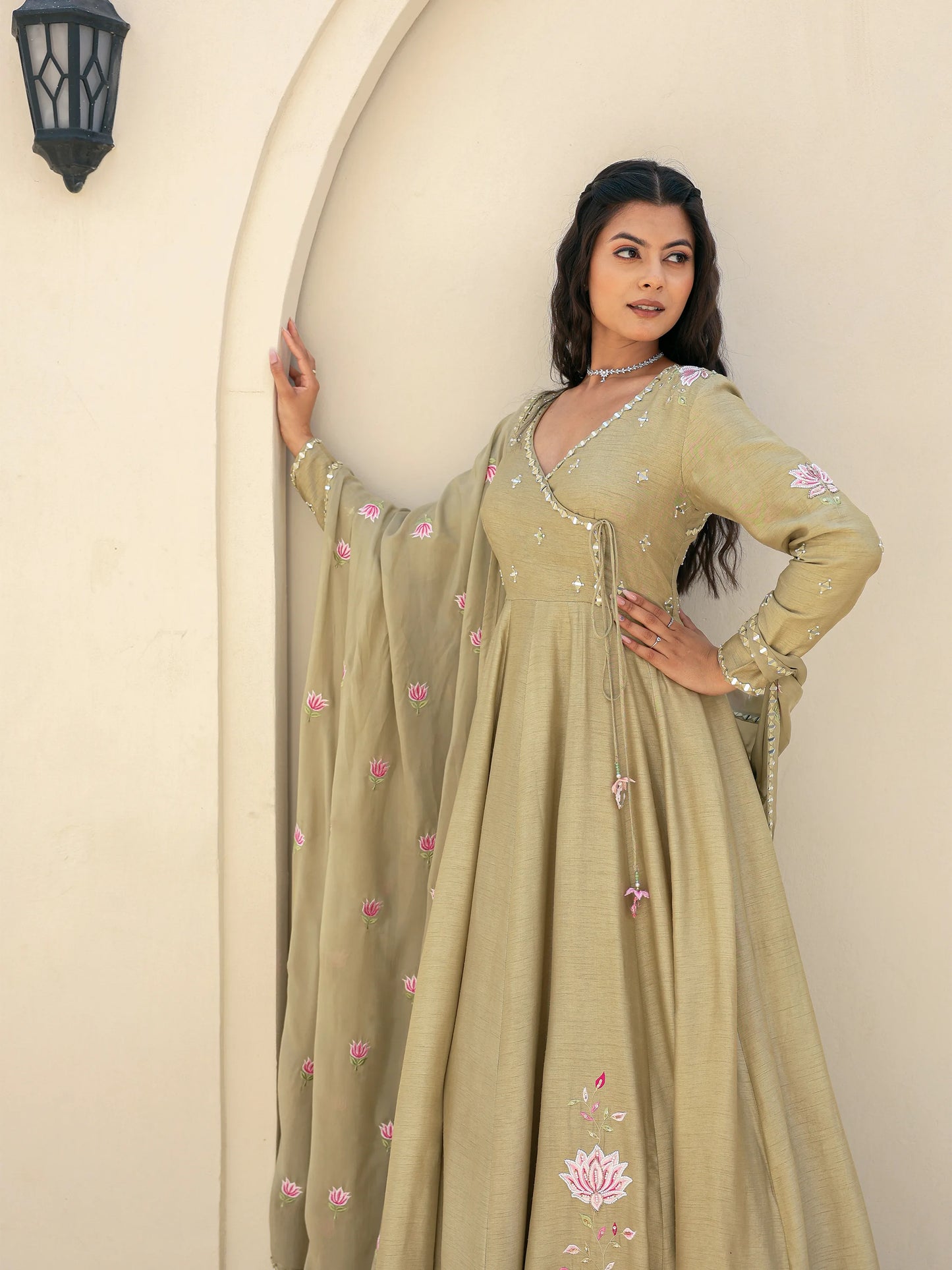 Sage green traditional Anarkali with floral motifs and mirror work.