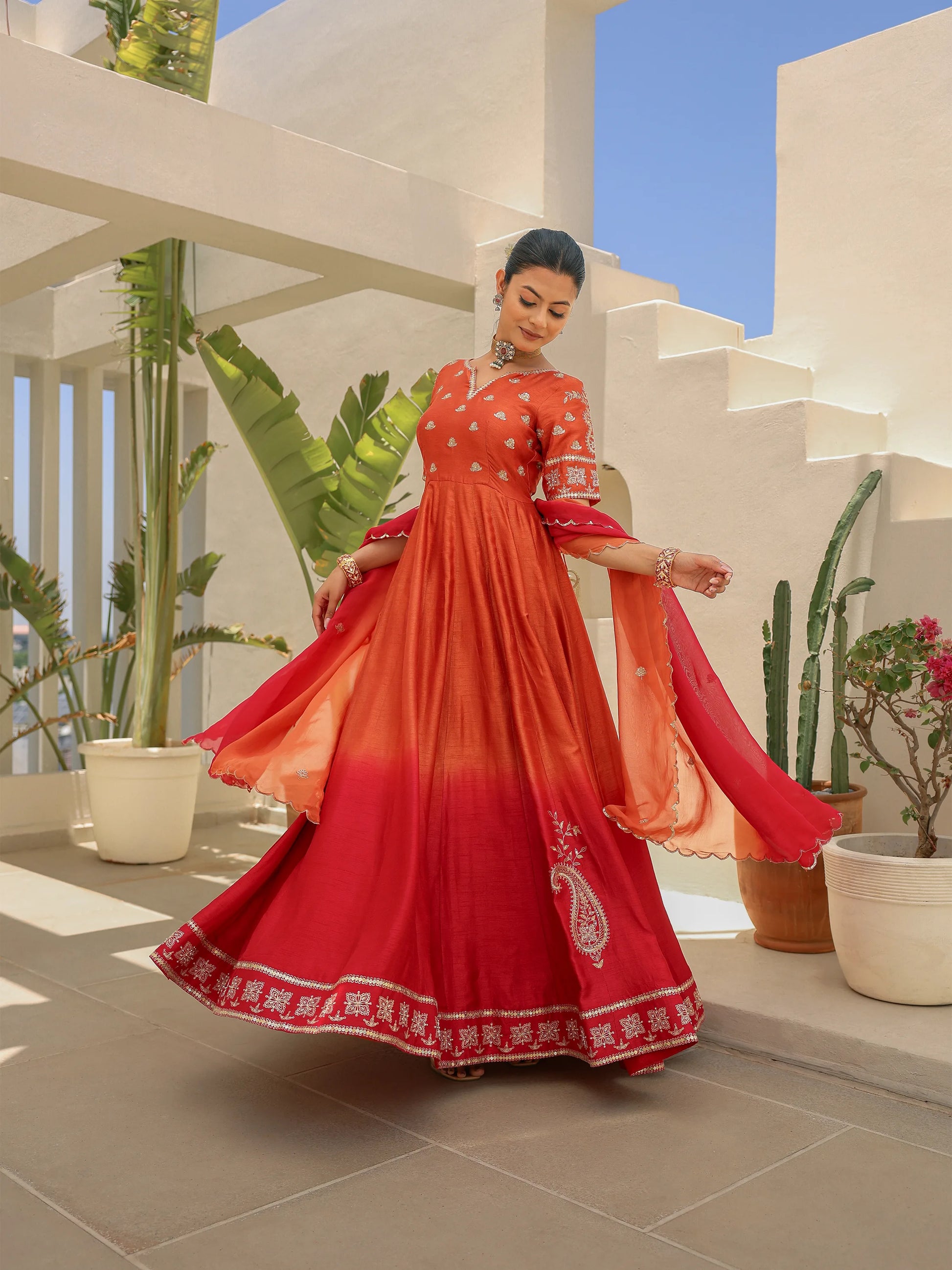 Model twirling in a rustic orange ombre Anarkali styled with a shaded dupatta.