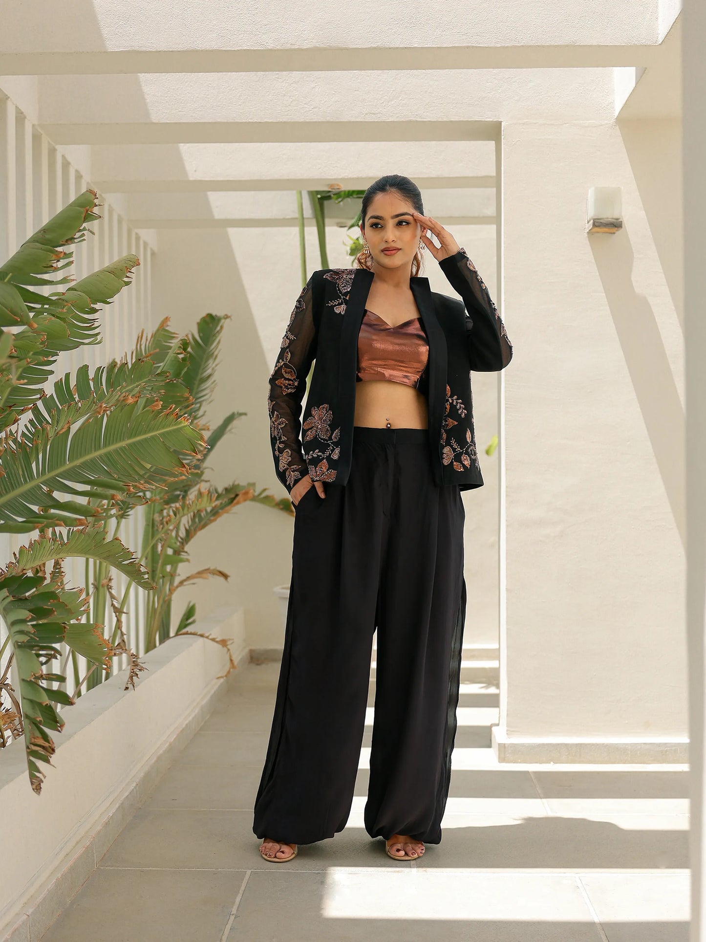 Black embroidered blazer co ord set with sheer floral sleeves and palazzo pants for weddings and parties.