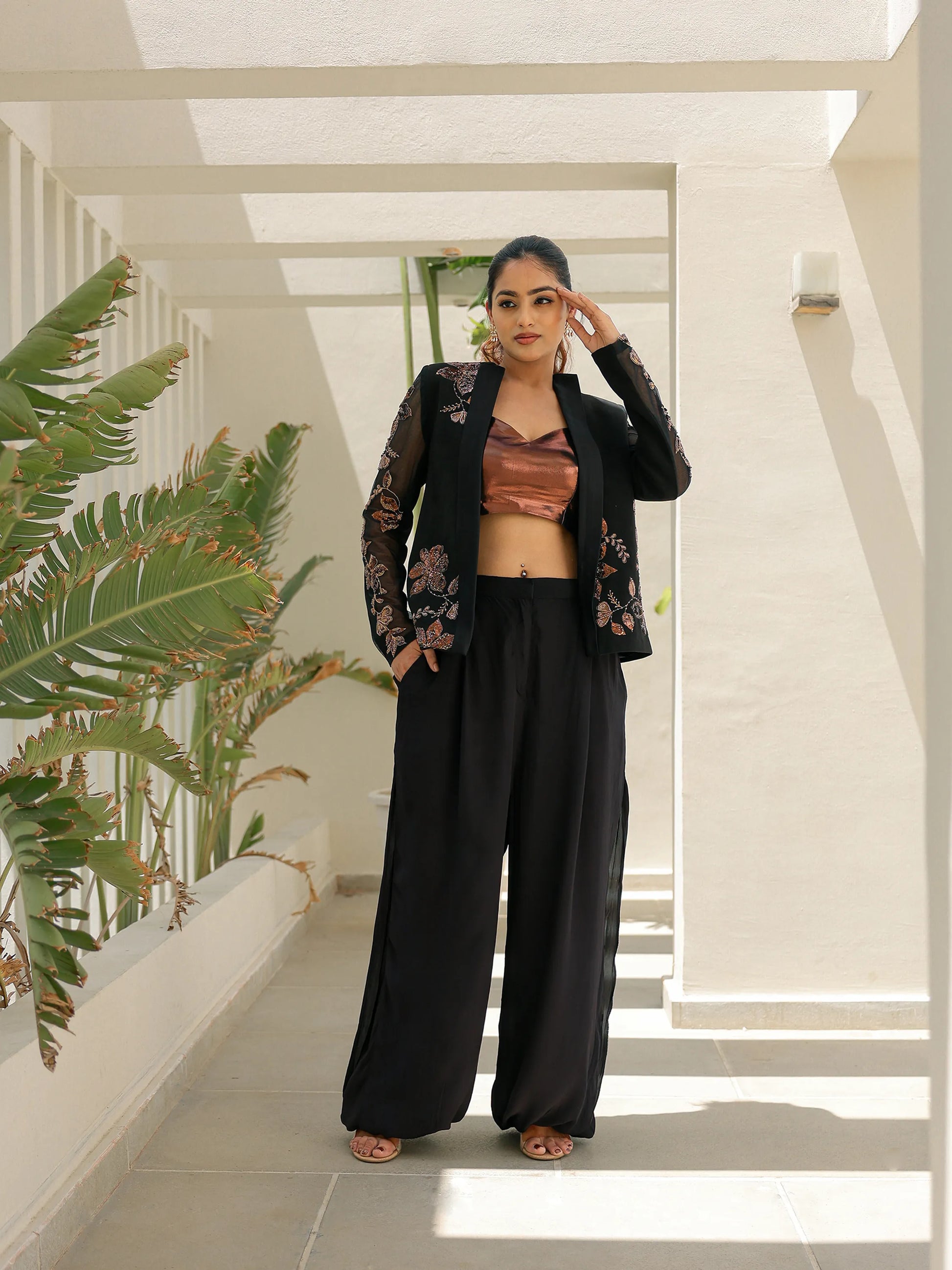 Black embroidered blazer co ord set with sheer floral sleeves and palazzo pants for weddings and parties.