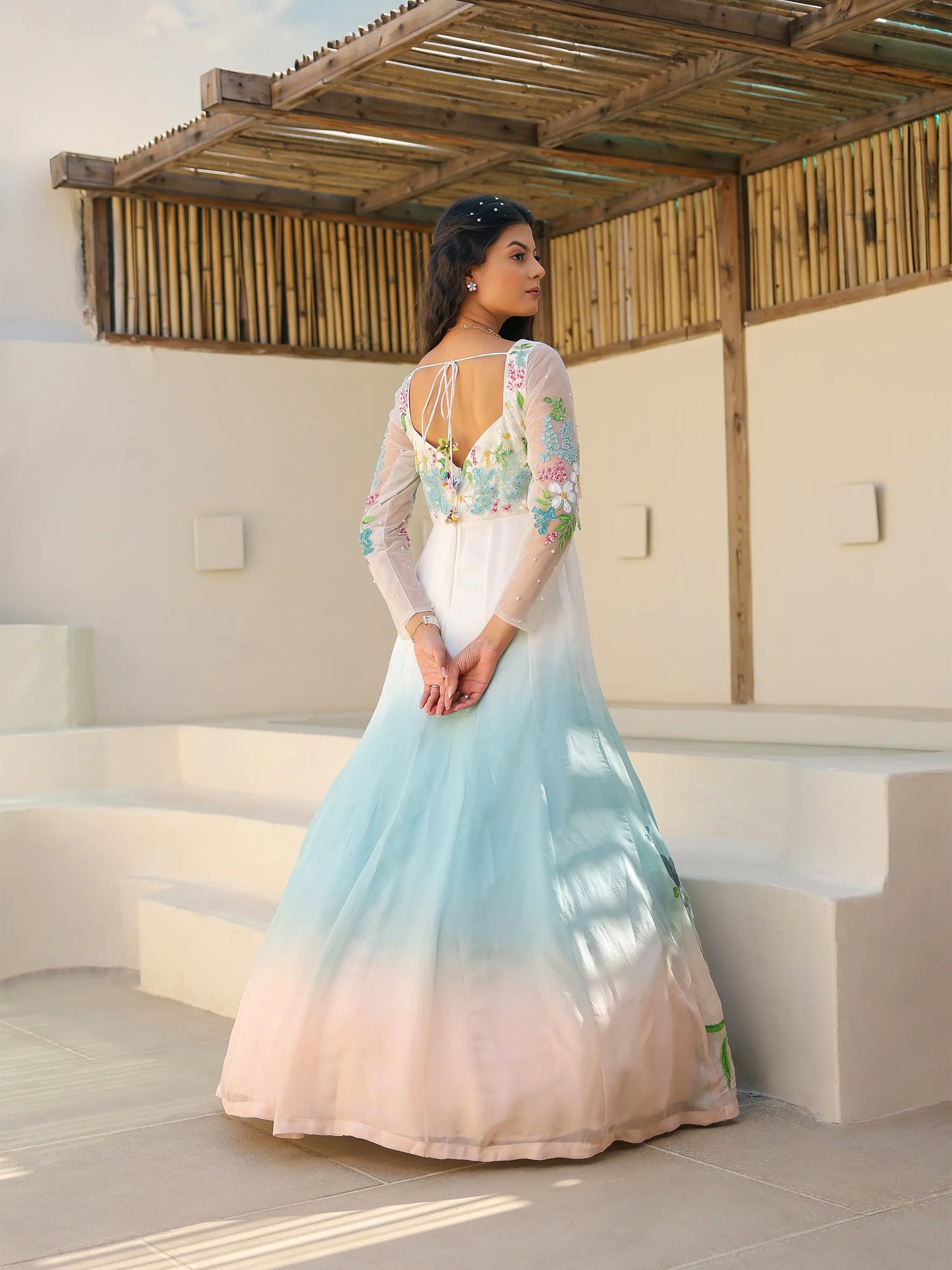 Back view of coastal ombre viscose organza gown with tie back neckline and hand painted embroidery