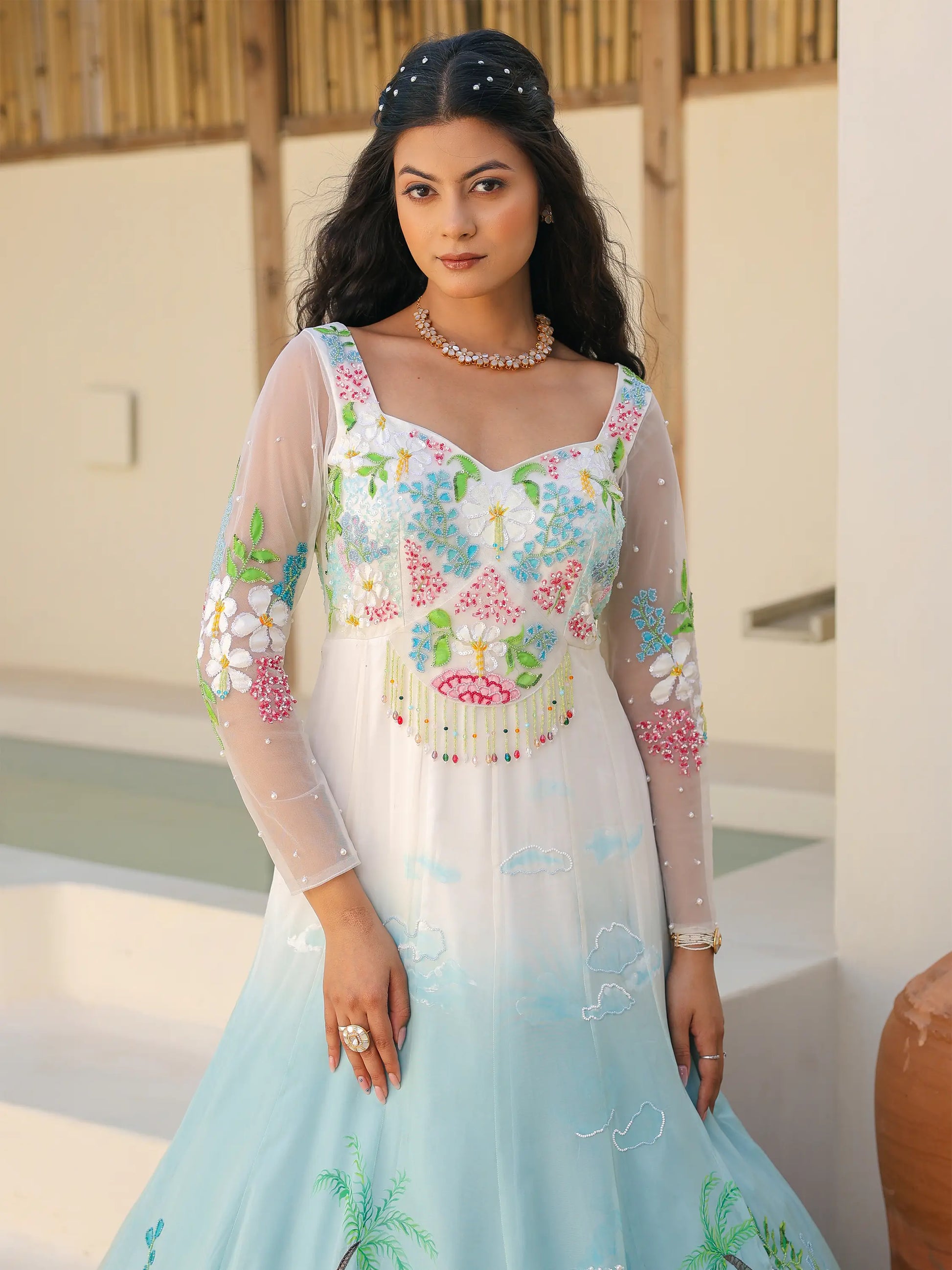 Hand painted floral bodice detail on coastal ombre viscose organza gown with pearl and sequin embellishments