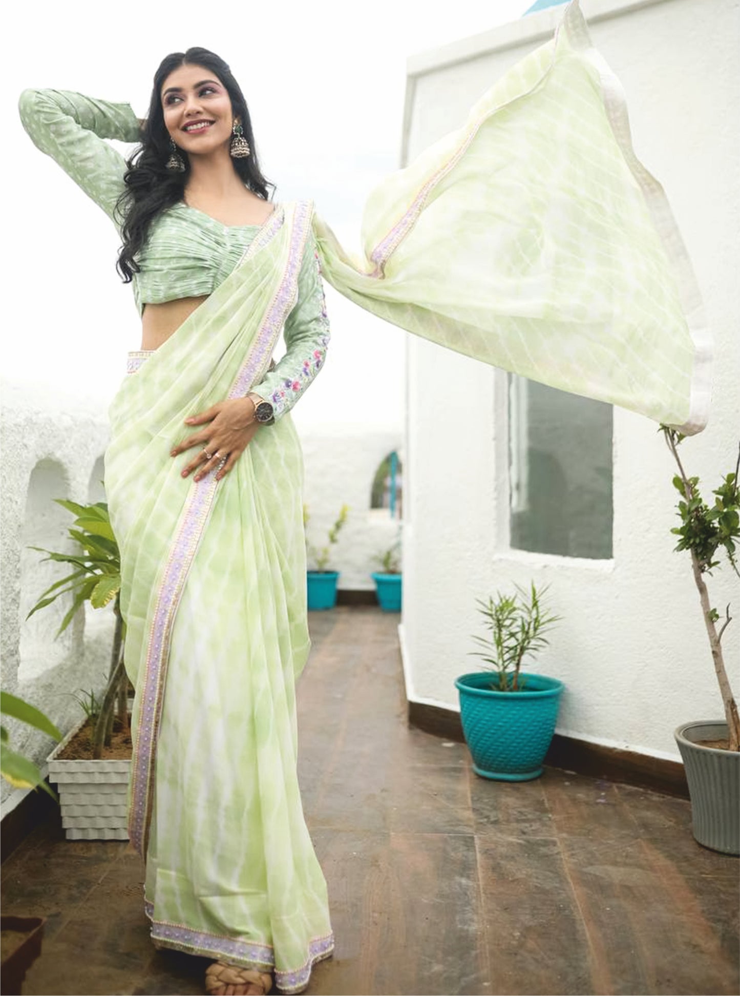 Swamp green drape saree crafted made from soft silk fabric.