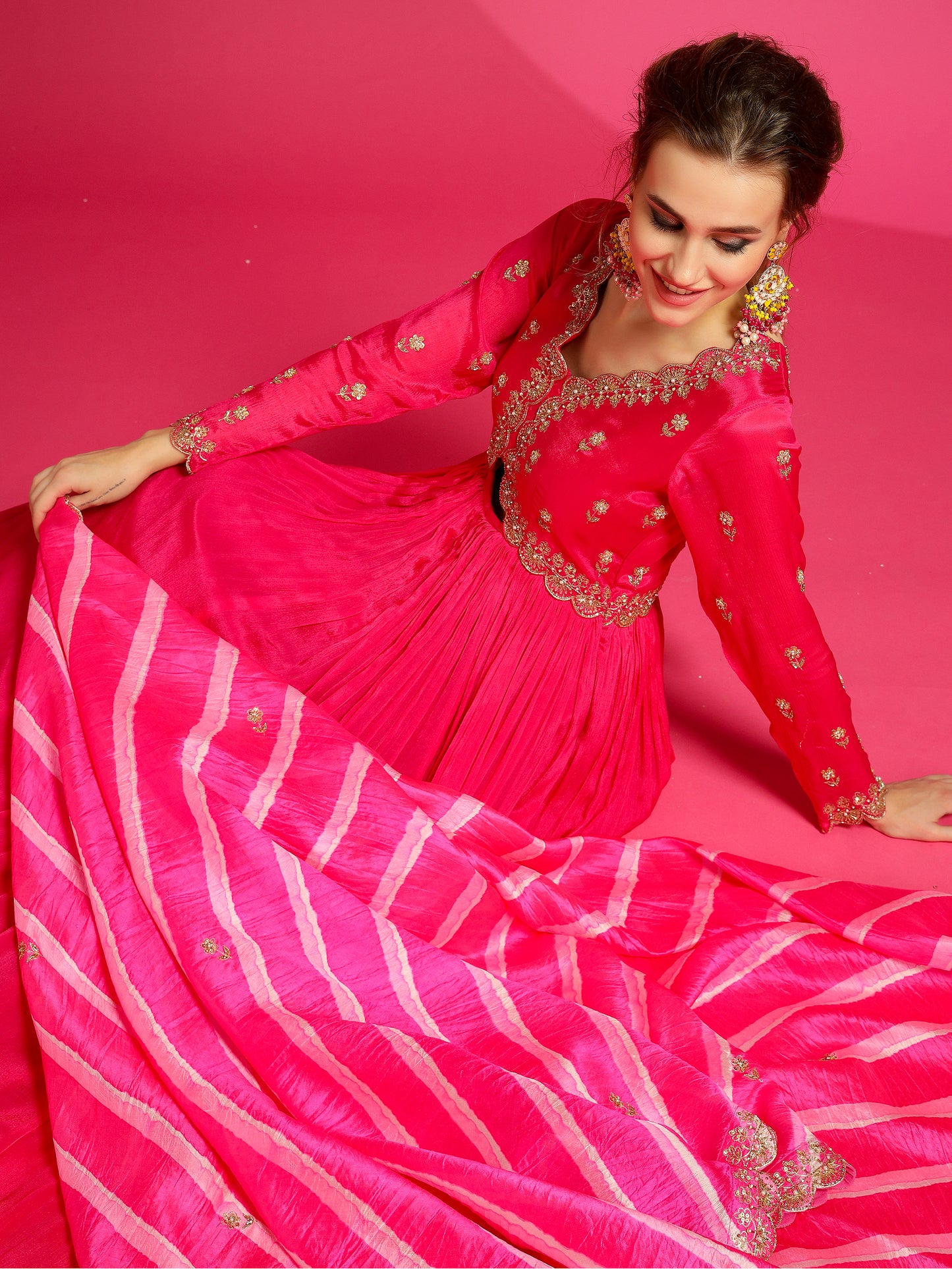 Rani pink handmade gown for engagement ceremony.