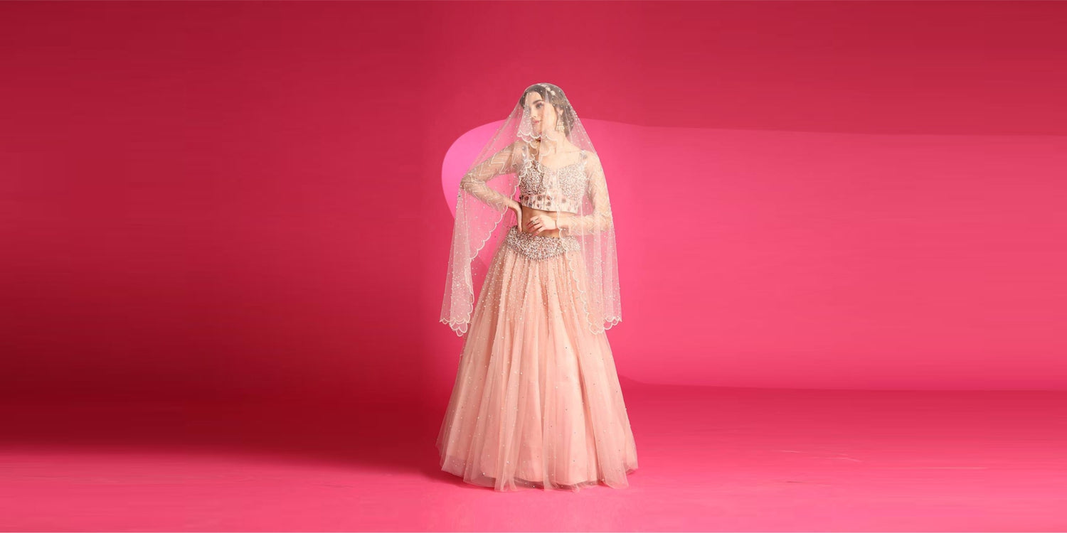 A misty rose coloured lehenga set with pearl work, ideal for engagements