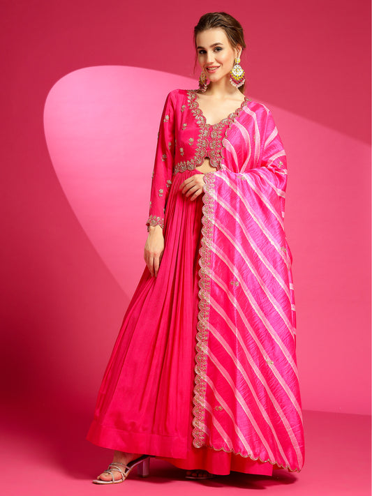 Dive into elegance with our luxurious rani pink gown, paired with a Tussar Silk Laheriya dupatta. 