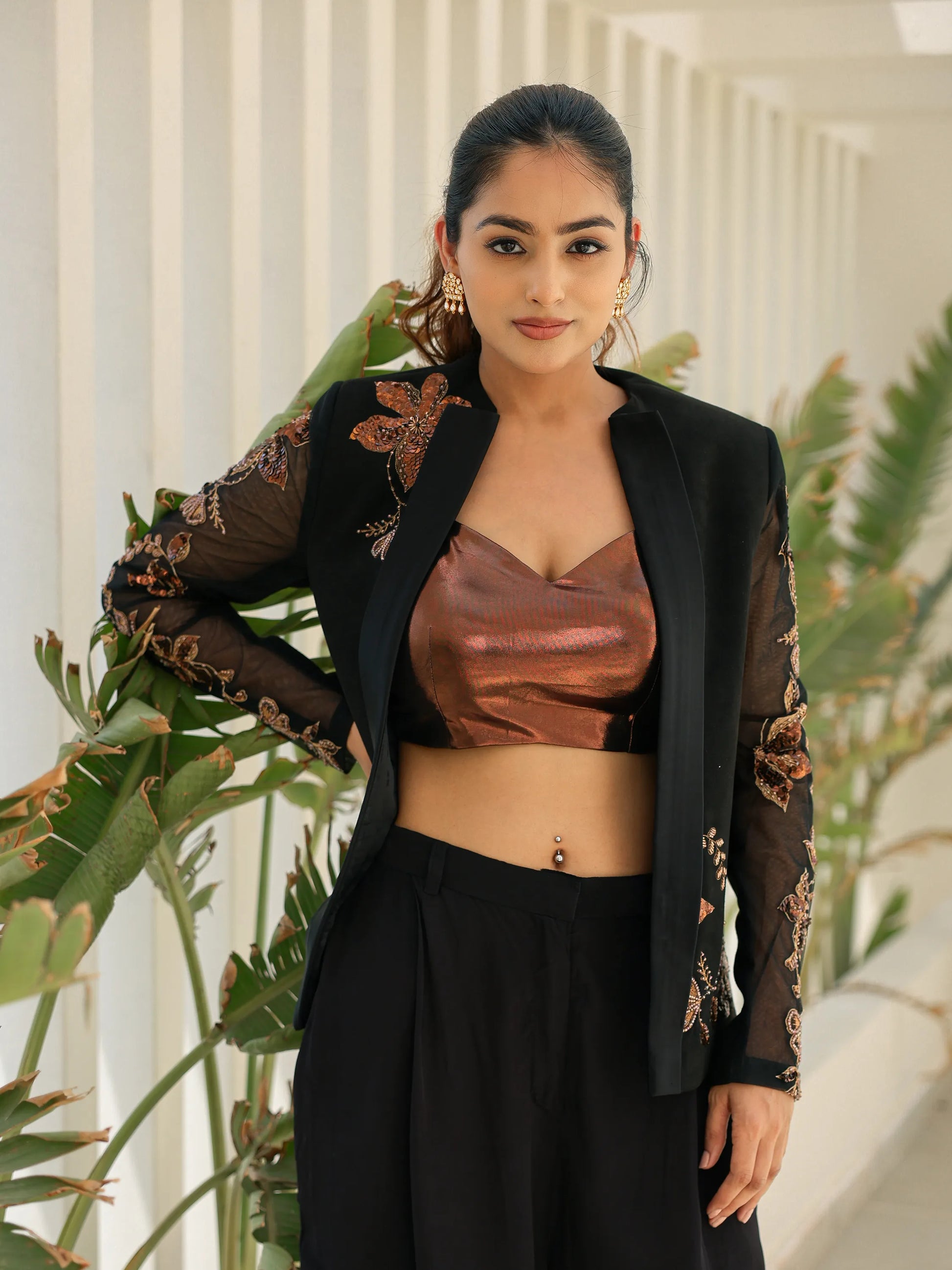 Modern black embroidered blazer outfit with bronze blouse and flowy pants for festive occasions.