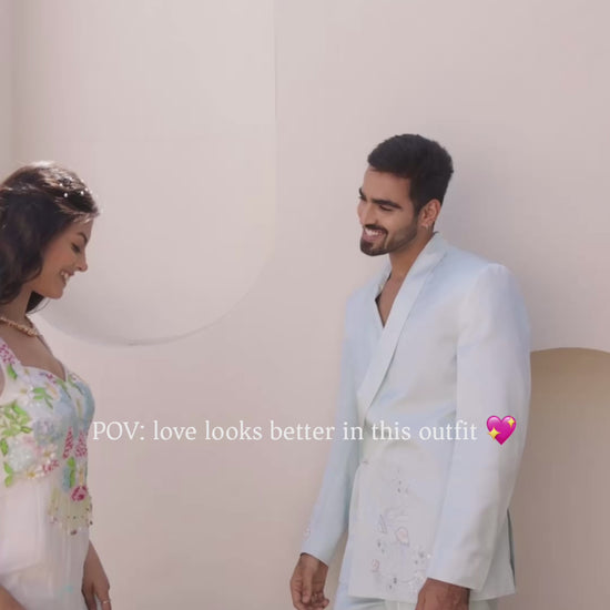 Coastal ombre viscose organza embroidered gown with hand-painted floral motifs, pearl and sequin embellishments, paired with soft net dupatta, styled for wedding and festive wear with a matching pastel suit couple look
